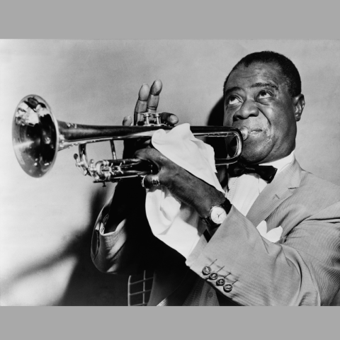 Louis Armstrong playing a trumpet.